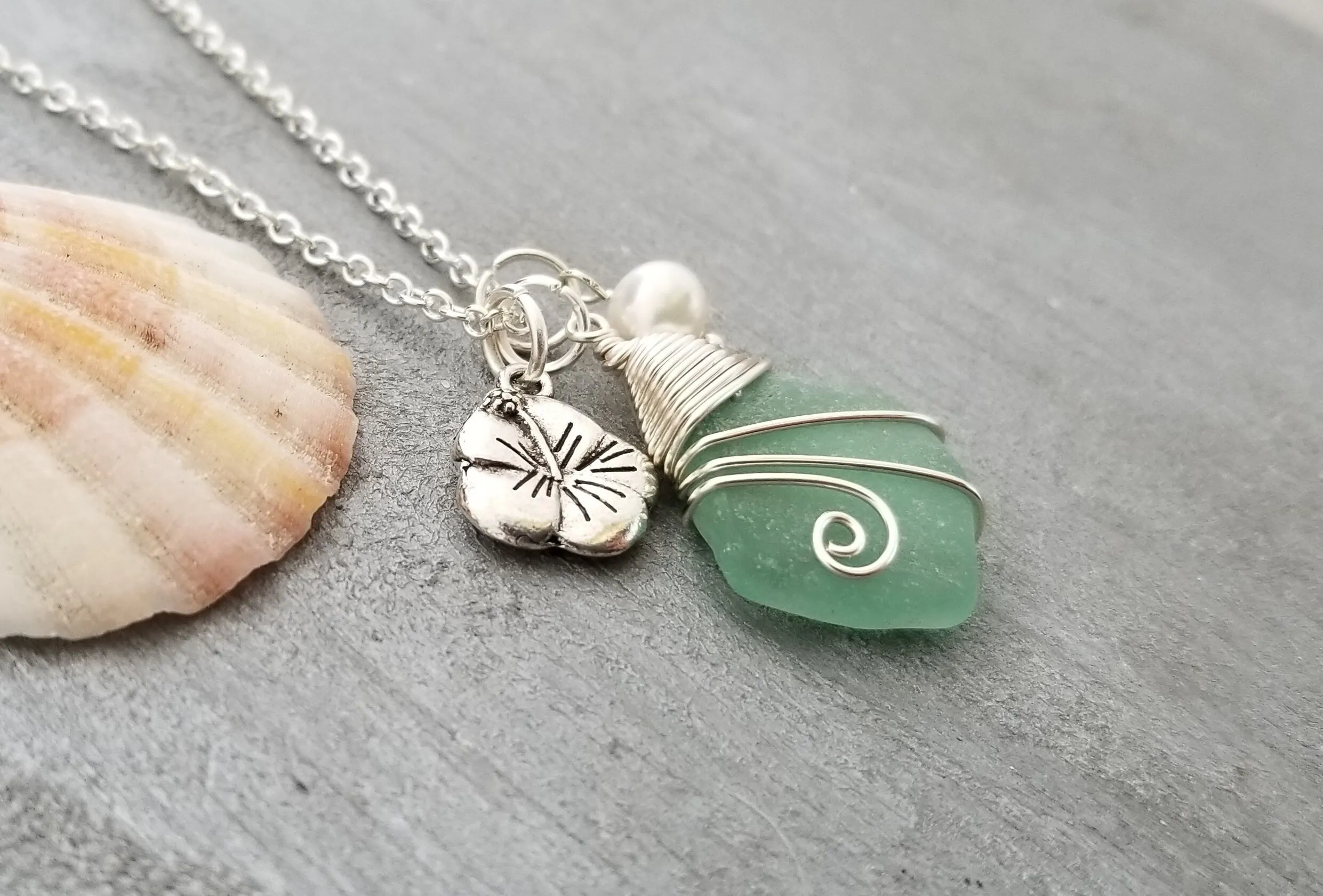 Handmade in Hawaii, Wire wrapped Genuine surf tumbled natural sea glass necklace. Hibiscus  charm, Natural pearl