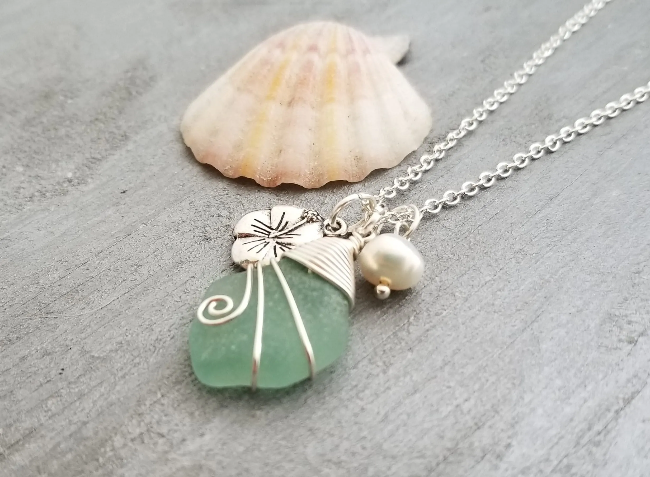 Handmade in Hawaii, Wire wrapped Genuine surf tumbled natural sea glass necklace. Hibiscus  charm, Natural pearl