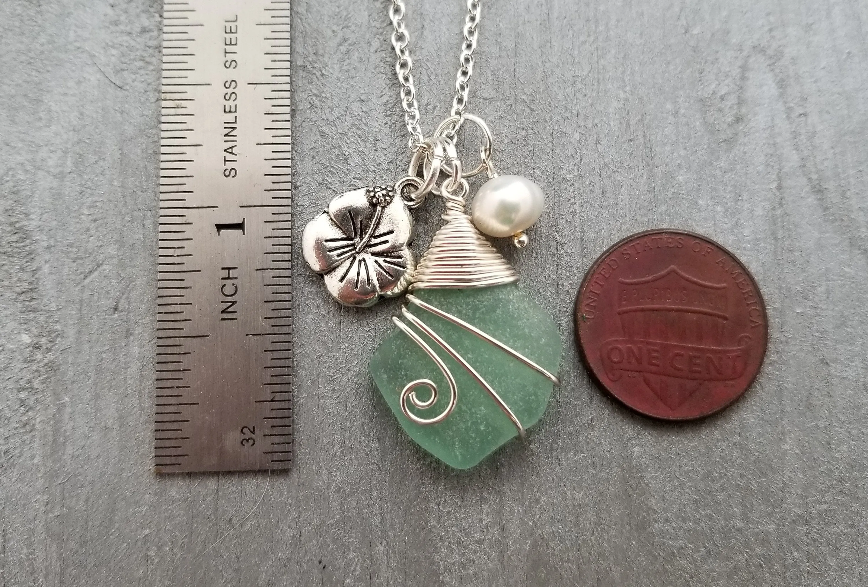 Handmade in Hawaii, Wire wrapped Genuine surf tumbled natural sea glass necklace. Hibiscus  charm, Natural pearl